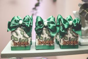 Set of decorated gift boxes with green bows and tropical leaf pattern, labeled Lorenzo.